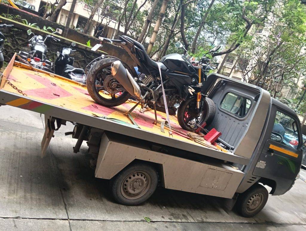 High-end BMW G 310 R sport bike secured for transport on a specialized tow carrier.